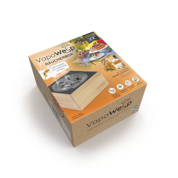 Die VapoWesp Räucherbox ist eine braune Schachtel mit Abbildungen von Lebensmitteln und dem Produkt auf der Verpackung – ein natürliches Insektenschutzmittel, ideal, um Wespen bei Mahlzeiten im Freien fernzuhalten.