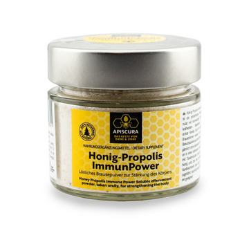 Ein Glas Honig-Propolis Immunpower Nahrungsergänzungsmittel mit gelbem Etikett, das die natürlichen Vorteile von Propolis und Honig kombiniert.